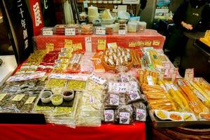 Osaka, Japan, 2018 - Japanese dry food and pickle vegetables for sale with names and price labels in Japanese language at Kuromon street market, Osaka, Japan. photo