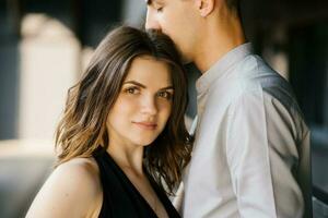 Head shot of young affectionate romantic couple in love.Concept of first kiss, tenderness and amorousness. Close up portrait of attractive brunette girl and guy with eyes closed, close to each other. photo