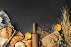 bread and bakery ingredients on black stone background photo