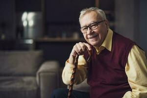 Elderly man with female caretaker at home. Health concept. photo