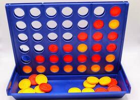 Connect 4 board game for kids,logical strategy game children red yellow chips on a white background,reto style photo