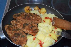 Breaded Fish with Poatos in the Pan photo
