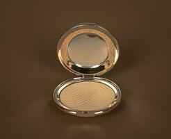 Super luxury Women's face powder in a golden box with a mirror on a brown background. new-3 photo