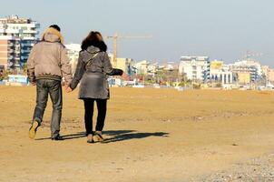 Couple walking on the beach photo