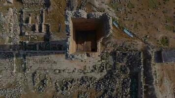 Drone shot undestroyed tall tower in historical stone architecture, bird's eye view of ruined building and tall tower built with stones, Sanliurfa Turkey video