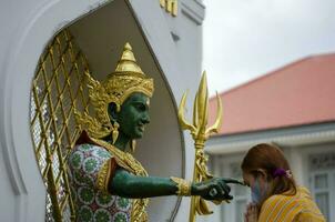 Bangkok, Thailand - April 22, 2023 Worship Devaraj Neramit or Thep Tanjai statue, Thewarat Kunchorn Worawihan Temple photo
