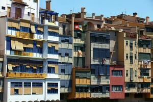 Girona, Spain 2013, blinds from the summer sun on the windows of colorful houses photo