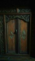 Javanese traditional door with carved carvings made of wood photo