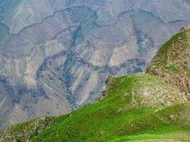 Minimalistic landscape of rocky ledge. Edge of the cliff, a dangerous gorge. photo