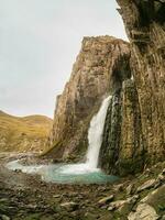 Autumn mountains in autumn morning. Gil-Su waterfall in wide autumn valley in North Caucasus, Russia. Beautiful vertical landscape. photo