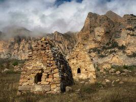 Old Ossetian family crypt in the misty mountains. Digoria region photo