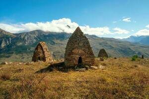 Old stone tomb, a crypt on the top of a mountain. Ossetia region. photo