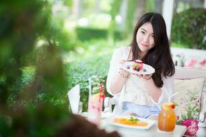 Pretty girl is enjoy with dessert and drinks photo