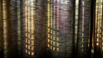 The windows' shadow projected on the fabric curtains  by the warm morning sunlight photo