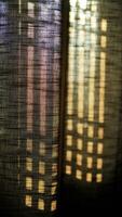 The windows' shadow projected on the fabric curtains  by the warm morning sunlight photo