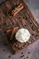 A cup of sweet Vienna coffee with whipped cream on a dark background top and vertical view photo