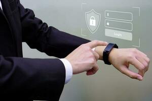 Close up hand of businessperson touching smart watch and show enter the password before accessing. Concept of business, data security and data validation. photo