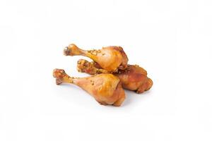 Delicious baked chicken drumsticks in honeymustard marinade isolated on white background. photo