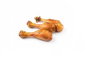 Delicious baked chicken drumsticks in honeymustard marinade isolated on white background. photo