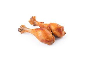 Delicious baked chicken drumsticks in honeymustard marinade isolated on white background. photo