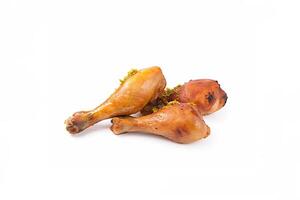 Delicious baked chicken drumsticks in honeymustard marinade isolated on white background. photo