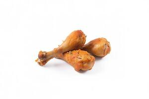 Delicious baked chicken drumsticks in honeymustard marinade isolated on white background. photo