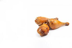 Delicious baked chicken drumsticks in honeymustard marinade isolated on white background with copy space. photo