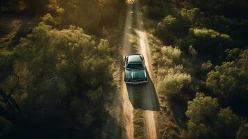 Aerial view of a car on the road in the forest.. photo