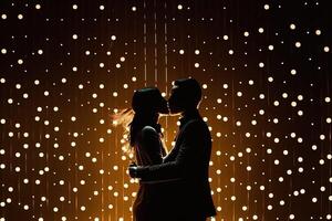 Silhouette couple dances in front of a wall of lights, exemplifying the energy and passion in their relationship, , valentine concept. photo