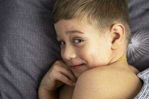 Portrait of a cute 5-year-old Caucasian boy who has just woken up photo