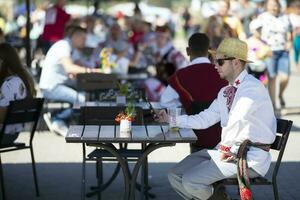 08 29 2020 Belarus, Lyakhovichi. City holiday. A Belarusian or Ukrainian man in an embroidered shirt sits at a table. photo