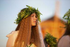 08 29 2020 Belarus, Lyakhovichi. City holiday. A beautiful girl in a wreath of herbs on Ivan Kupalya. photo