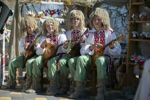 08 29 2020 Belarus, Lyaskovichi. Celebration in the city. Ethnic Slavic Ukrainian or Belarusian musicians with balalaikas. photo