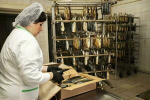 FSeptember 18, 2020. Belarus, Gamil. Fish factory.ish factory worker with smoked fish. Fish industry. photo