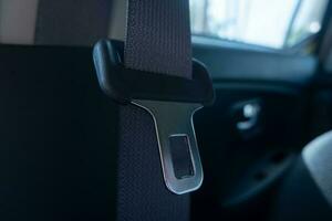 selective focus on car seat safety belt buckles. soft focus. under exposure photo