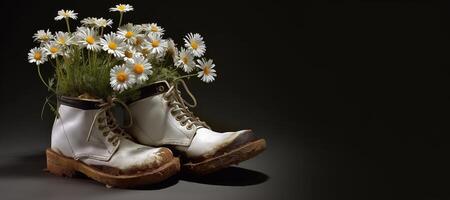 , Old boot with meadow spring flowers, handmade shoe planter. Environmental activism concept photo