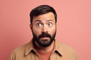 A man is being photographed on a solid background with a look of confusion on his face. photo