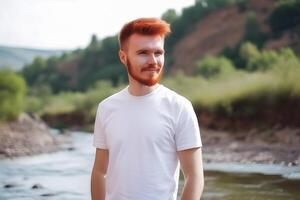 content, Mokkap, a man with a red beard in a white T-shirt on the background of nature. Place for design. photo