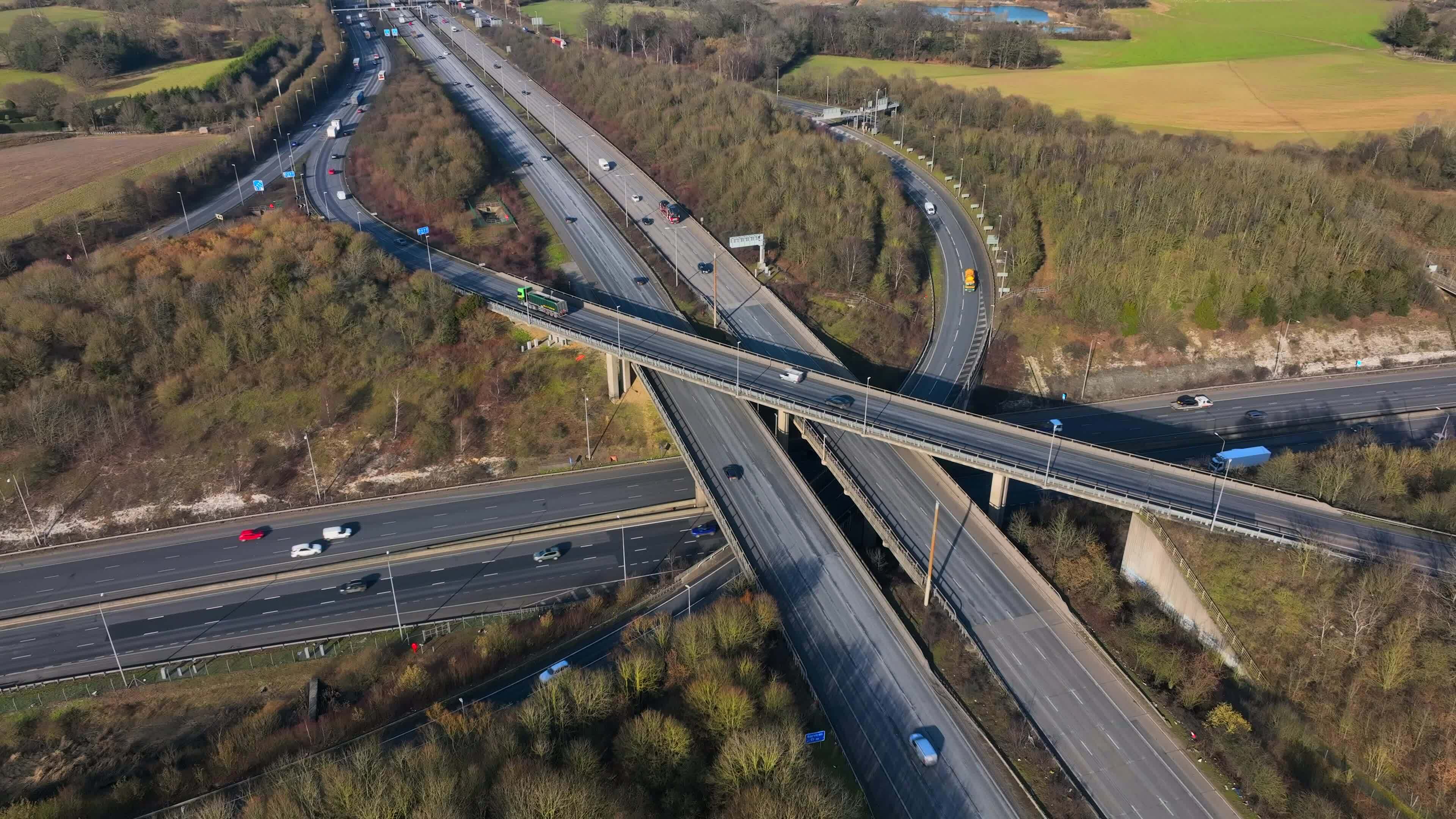 Vehicles Driving Along a Busy Motorway Interchange in the UK Aerial ...