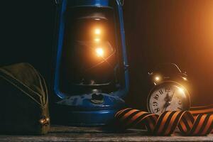 Russian soldiers cap, St. George ribbon, old retro alarm clock and kerosene lamp are illuminated by bright daylight.Victory Day is May 9th. photo
