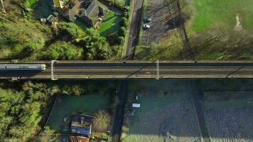 Fast Commuter Train Passing Over a Viaduct Bird's Eye View video