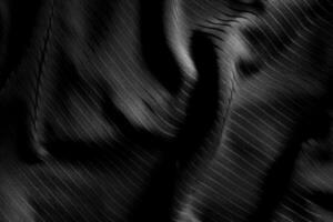 Dark black and gray blurred gradient and line of cloth or fabric background has a little abstract light. photo