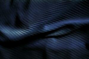 Dark black and gray blurred gradient and line of cloth or fabric background has a little abstract light. photo