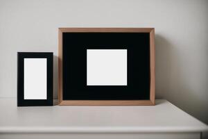 Photo frame on the wooden table. Blank wooden photo frame. Mock up.