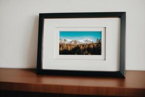 Photo frame on the wooden table. Blank wooden photo frame. Mock up.