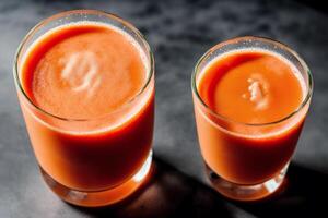 Carrot juice in a glass with fresh carrots on a dark background. close up. Healthy food concept. photo