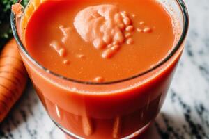 Carrot juice in a glass with fresh carrots on a dark background. close up. Healthy food concept. photo