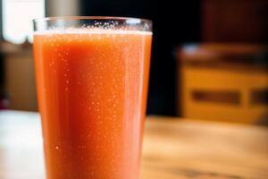 Carrot juice in a glass with fresh carrots on a dark background. close up. Healthy food concept. photo