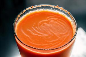 Carrot juice in a glass with fresh carrots on a dark background. close up. Healthy food concept. photo