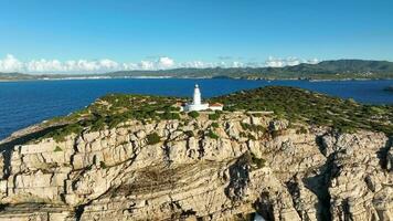 Lighthouse Atop A Steep Cliff Overlooking the Ocean in Ibiza video